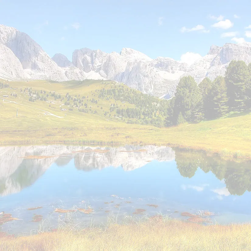Cataracts-Lanscape Simulation of cataracts showing a mountain landscape and reflective lake appearing heavily washed out, hazy, and low contrast, with faded colors and reduced clarity across the entire image.