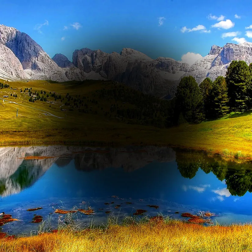 Macular-Degeneration-Lanscape Simulation of macular degeneration showing a mountain landscape and reflective lake where the central portion of the visual field is blacked out and the peripheral scenery remains visible and clear.